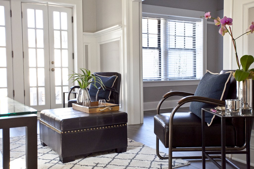 a living room with a leather chair and a