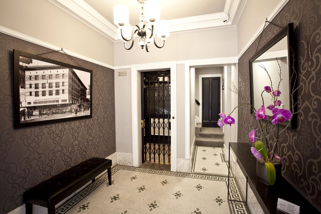 a view of a hallway with a mirror and a black door