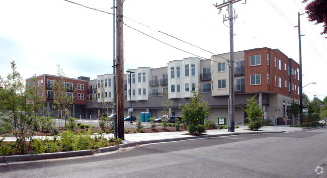 a row of new apartment buildings on a street corner
