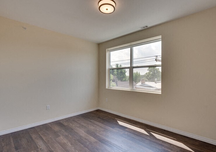 the living room of an empty house with a window
