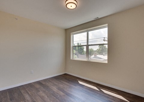 the living room of an empty house with a window