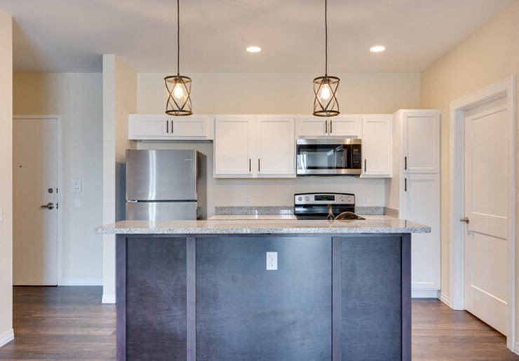a kitchen with white cabinets and a counter top