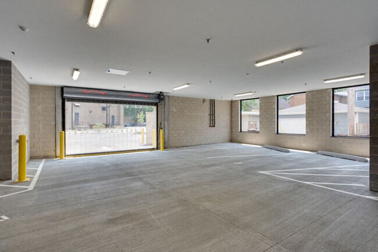 an empty parking lot in a building with a large window
