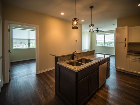 an empty kitchen with a sink and a counter top