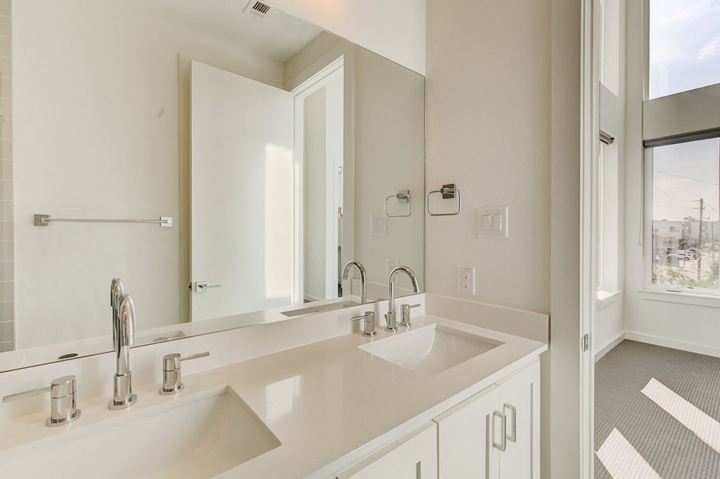 a bathroom with two sinks and a large mirror