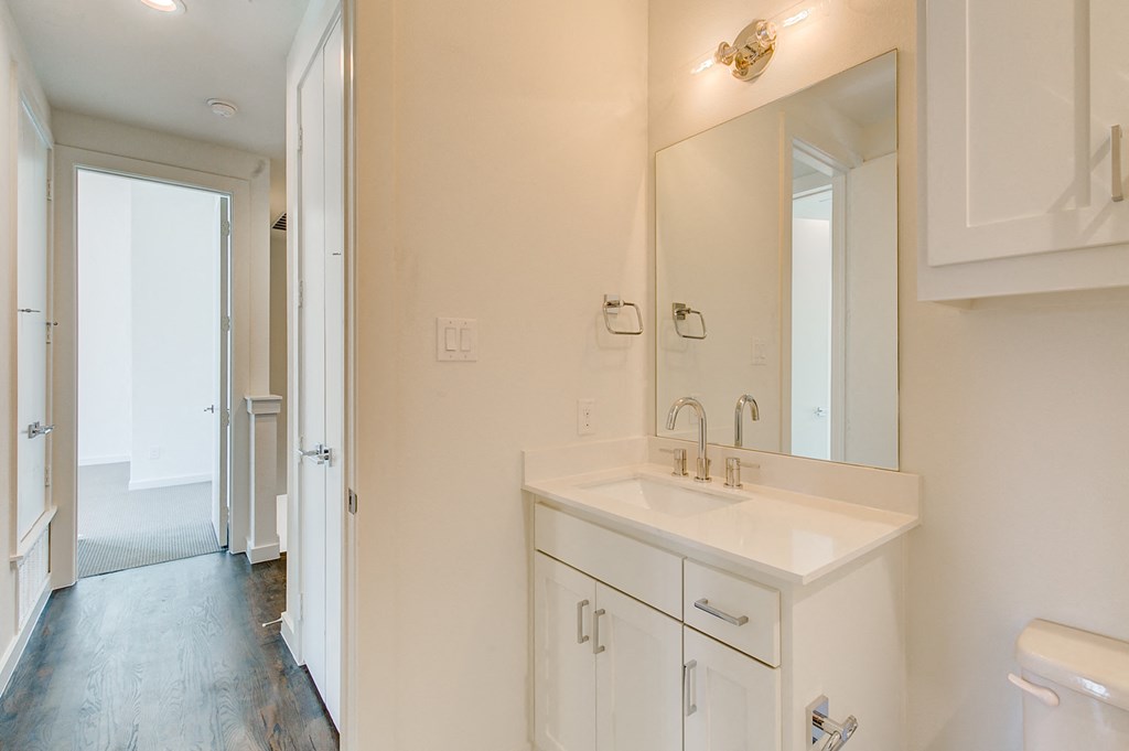 an empty bathroom with a sink and a mirror