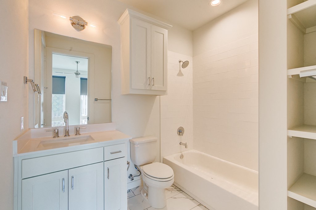 a bathroom with a sink toilet and a bath tub