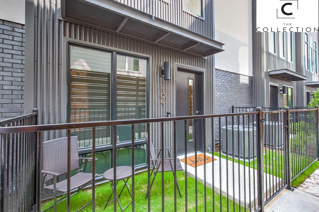 a balcony with a metal railing and chairs on it