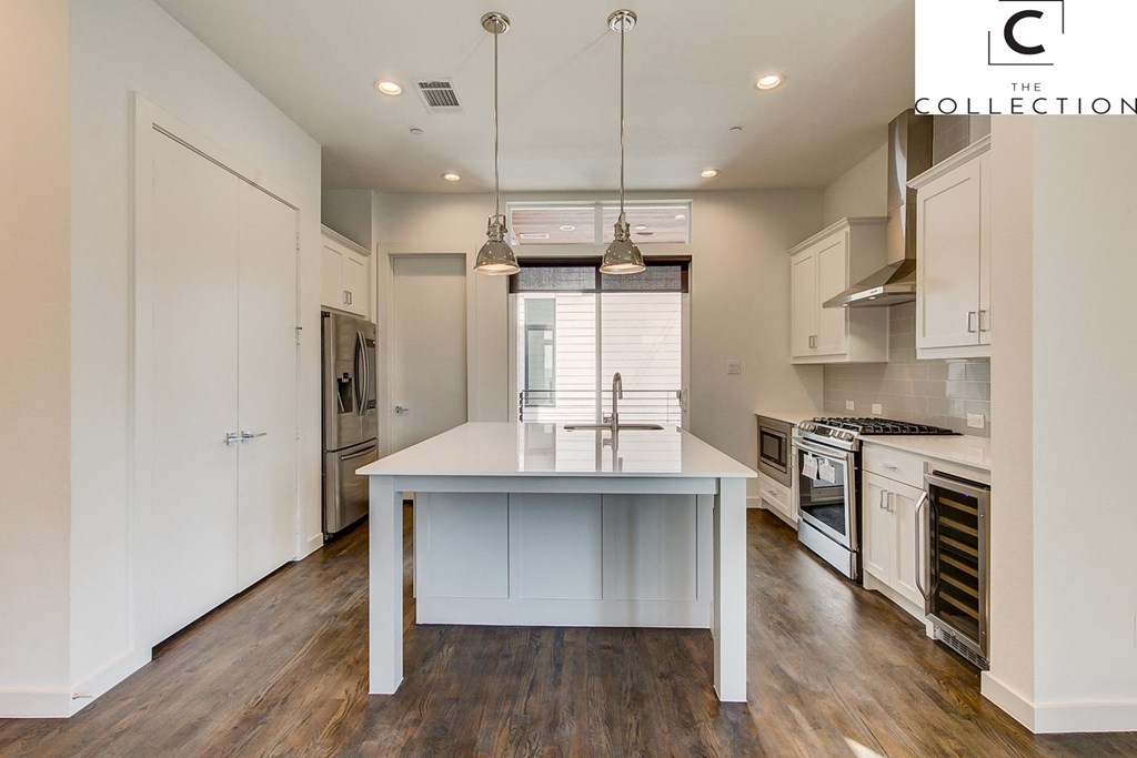 a kitchen with white cabinets and a white counter top