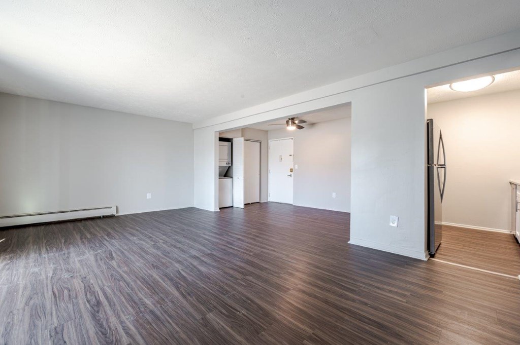 A room with wooden flooring and white walls.