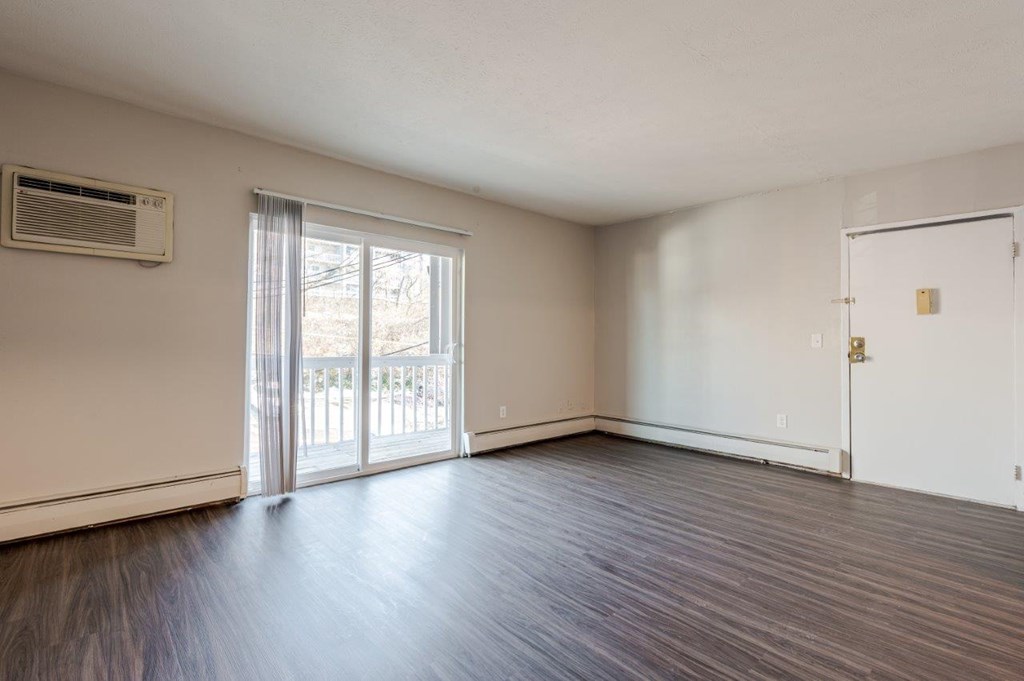 A room with a sliding glass door and a white door.