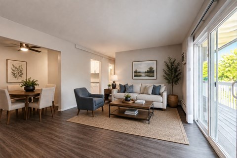 A living room with a sofa, chairs, and a dining table.