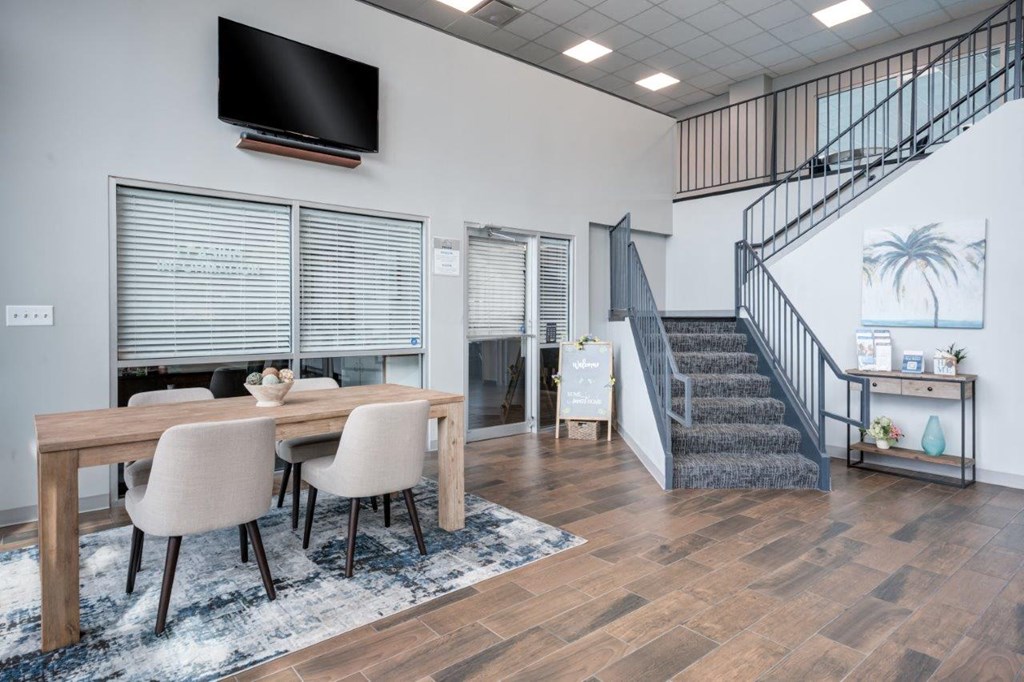 A modern dining room with a wooden table and chairs.