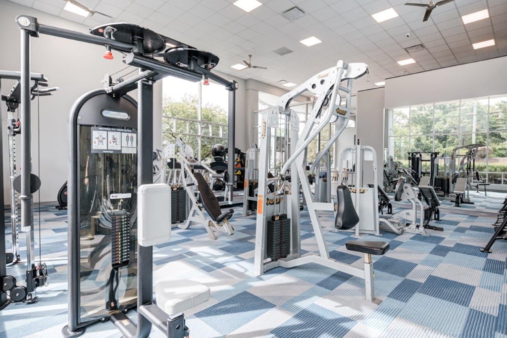 A gym with a variety of equipment including a leg press machine.
