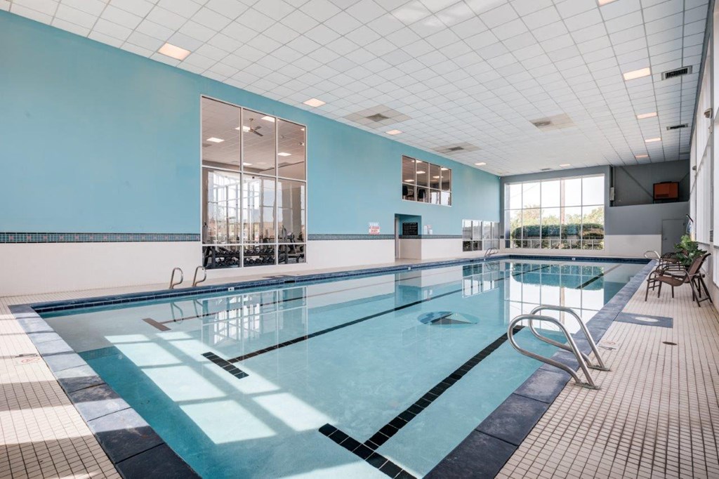 A large indoor swimming pool with a glass divider.