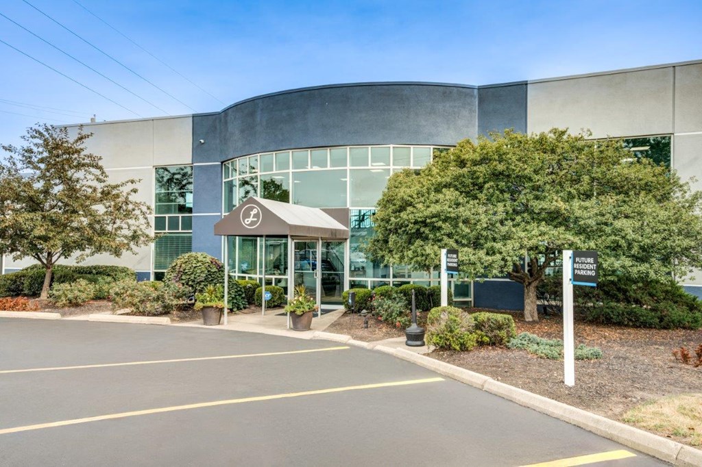 A modern building with a glass facade and a sign that reads "Hotel".