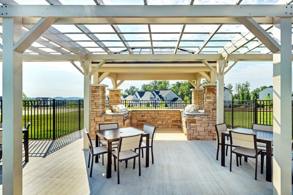 a patio with a table and chairs under a pergola