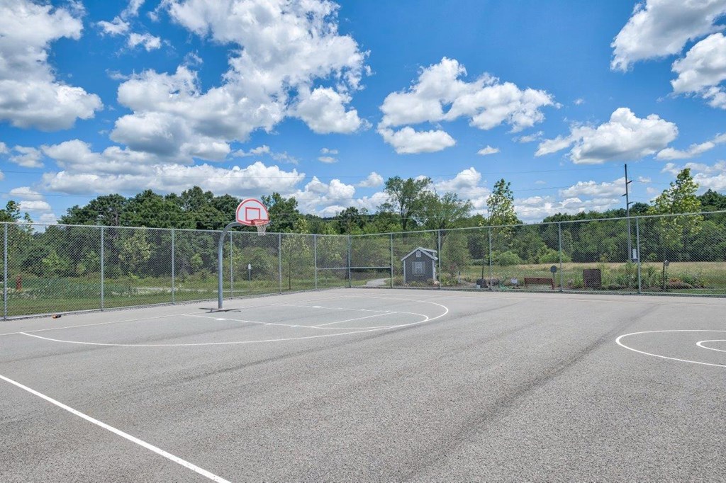 an empty basketball court with a red and white basketball