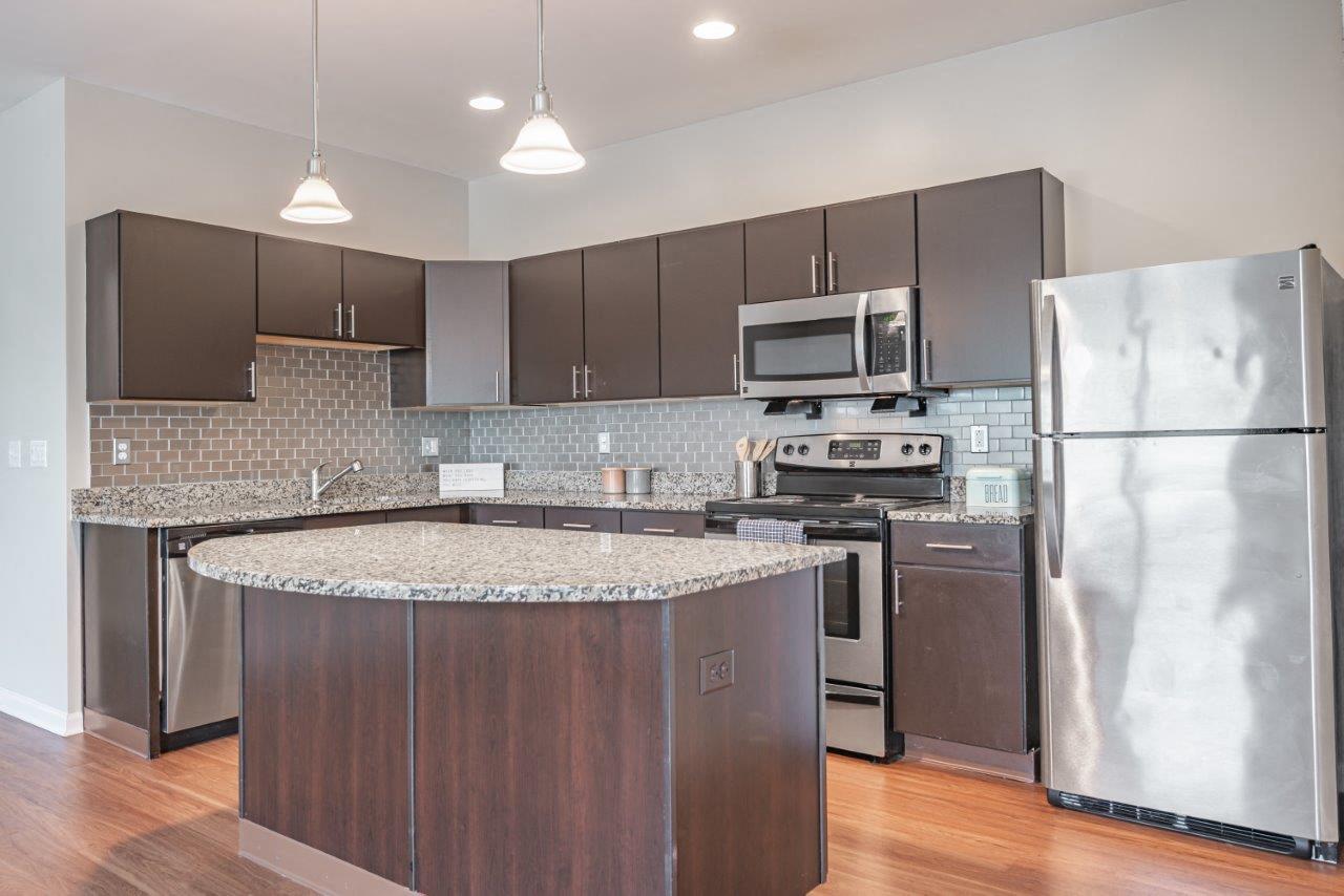 a kitchen with stainless steel appliances and granite counter tops