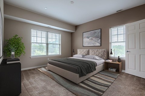 a bedroom with a bed and two windows