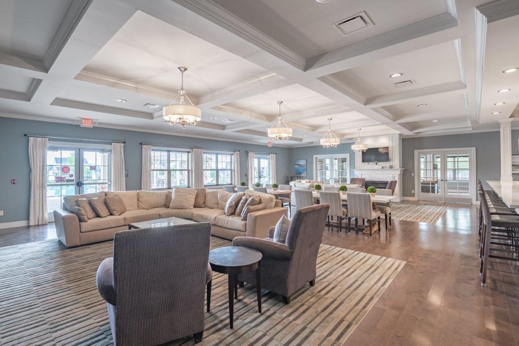 a large living room with couches and chairs and a bar