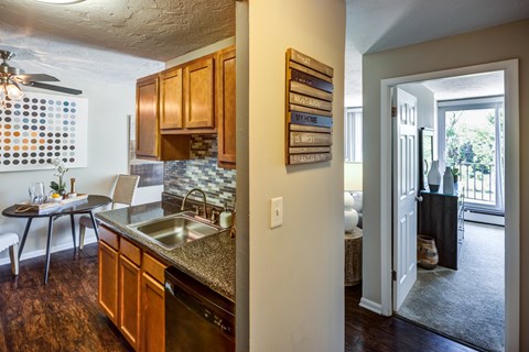 A kitchen with wooden cabinets and a dining table.