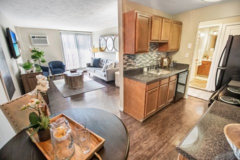 a view of a living room and a kitchen with a table