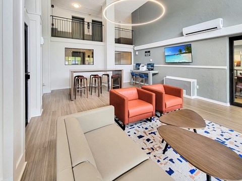 a living room with a couch and chairs and a table