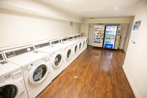 a washer and dryer room with a row of washing machines