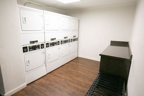 a room with white cabinets and a table and a counter