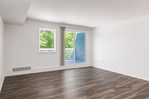 A room with a window and sliding glass door.