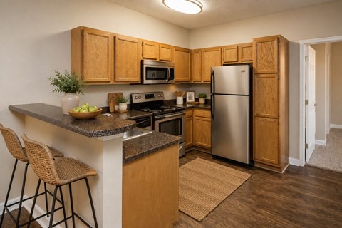 A kitchen with wooden cabinets and a granite countertop.