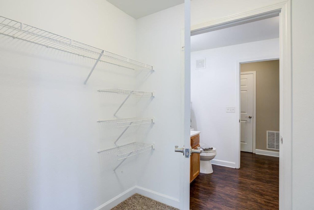 a bathroom with white walls and a white toilet