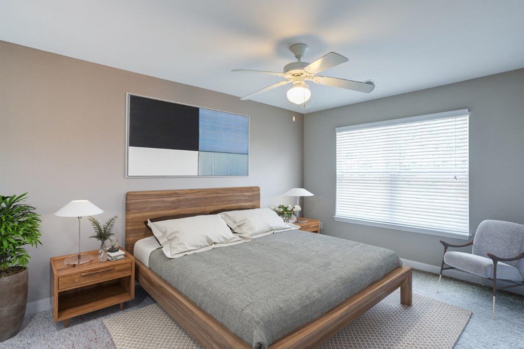 a bedroom with a bed and a ceiling fan