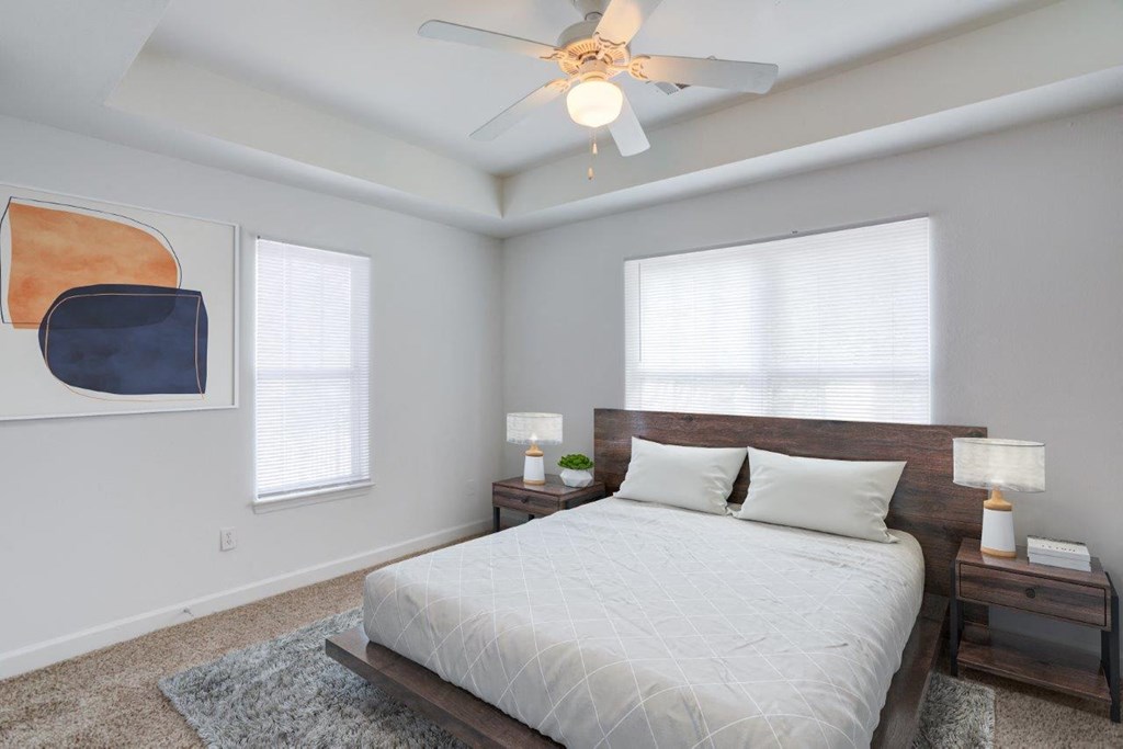 a bedroom with a bed and a ceiling fan