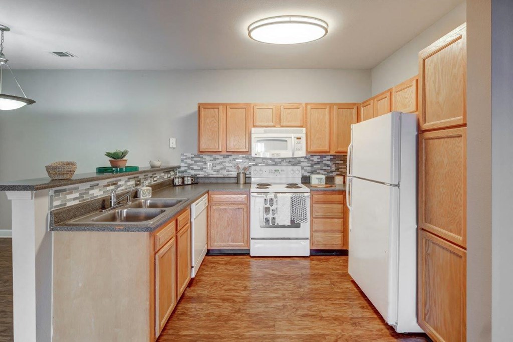 a kitchen with wooden cabinets and a white refrigerator