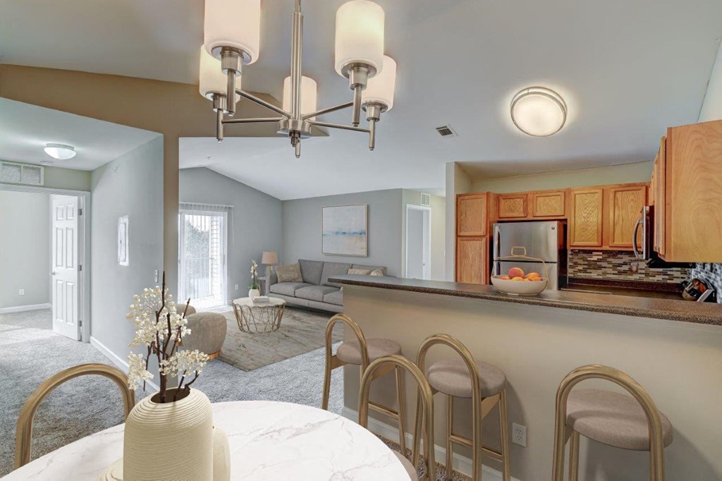 a kitchen and living room with a table and chairs