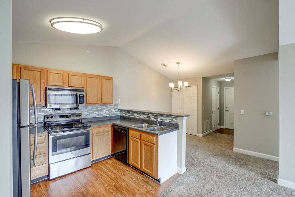 a kitchen with stainless steel appliances and wooden cabinets