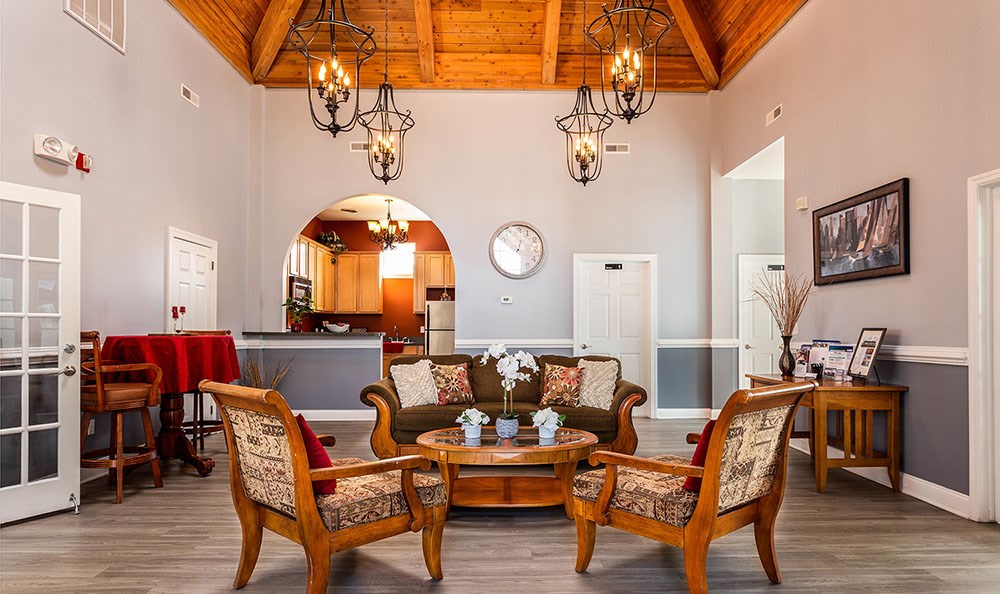 a living room with a table and chairs