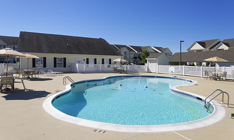 our resort style swimming pool is in front of our building and has tables and chairs