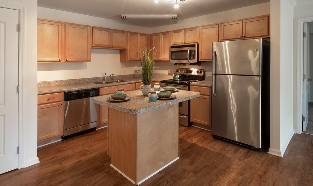 a kitchen with stainless steel appliances and wooden cabinets