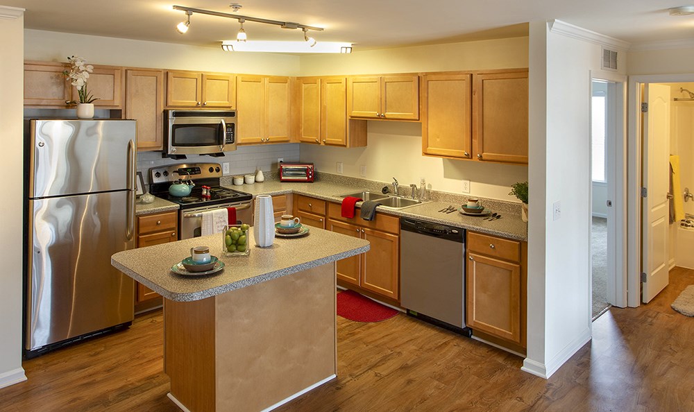a kitchen with stainless steel appliances and wooden cabinets