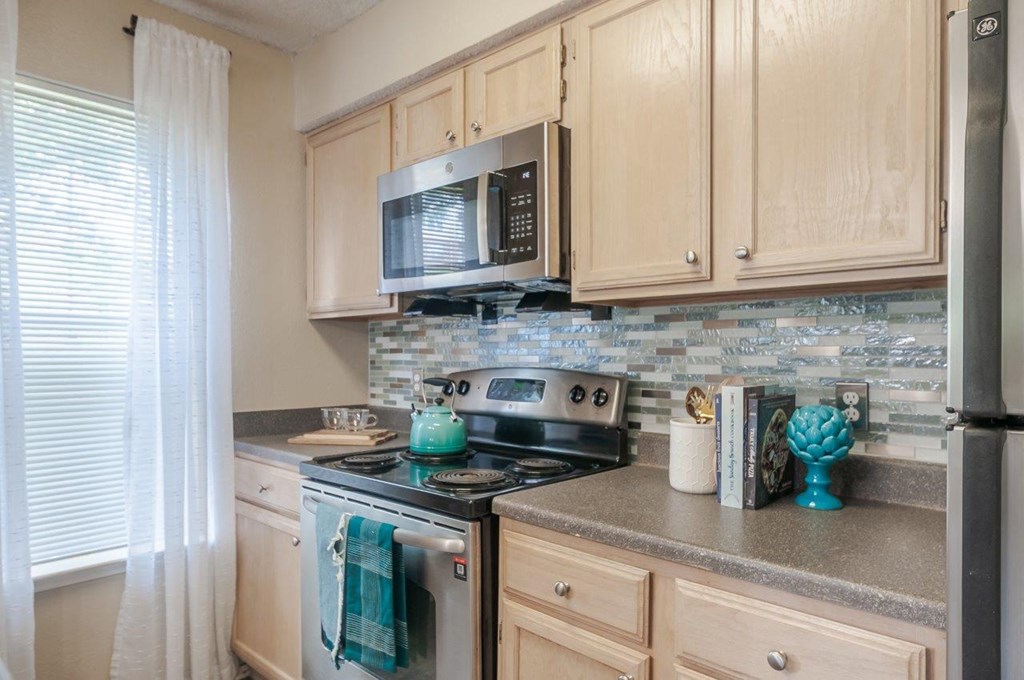 a kitchen with a stove and a microwave