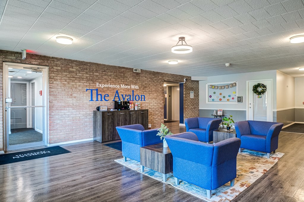 the lobby with blue chairs and a reception desk