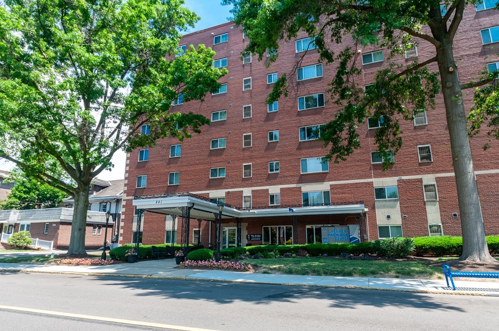 our apartments are located in a large brick building with trees