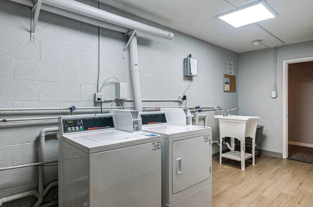 a laundry room with two washers and two machines