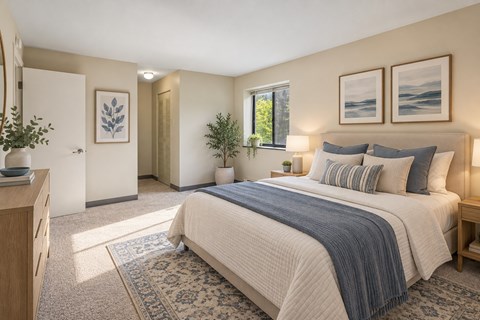 A bedroom with a large bed and a window.