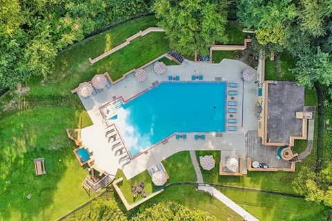 An aerial view of a backyard with a swimming pool and a deck.