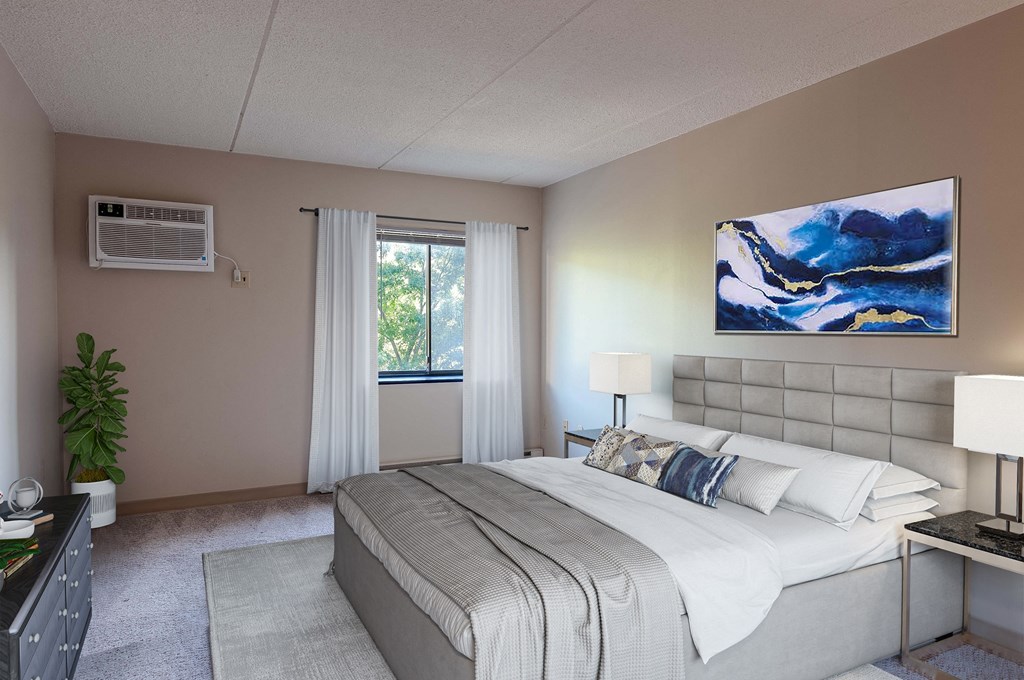 a bedroom with a bed and a painting on the wall