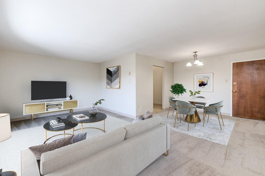 a living room with a couch and a table with chairs and a television